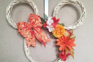 mickey mouse form wreath with artificial flower and ribbon accents in fall colors www.emjaybeedesign.com