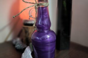 Purple shimmery potion elixir in a bottle with crystals www.emjaybeedesign.com