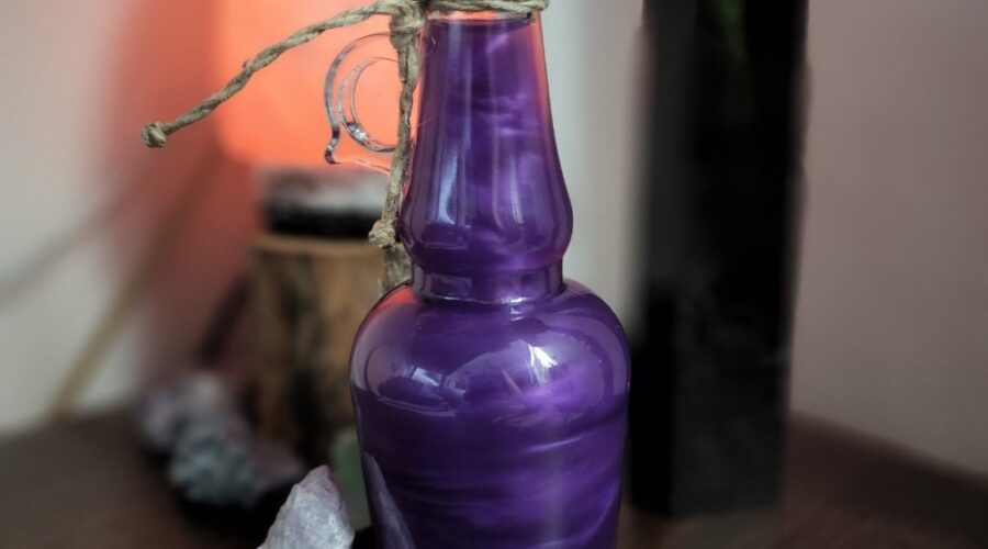 Purple shimmery potion elixir in a bottle with crystals www.emjaybeedesign.com