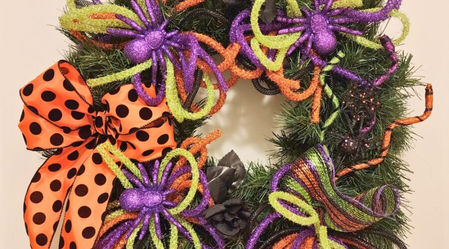 repurpose an old wreath for halloween with mesh tube, purple spiders, and a orange and black bow www.emjaybeedesign.com