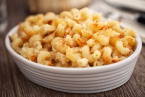 shrimp macaroni and cheese in a white dish www.emjaybeedesign.com