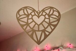 poster board cutout hearts hanging from the ceiling for valentine's day decorations www.emjaybeedesign.com