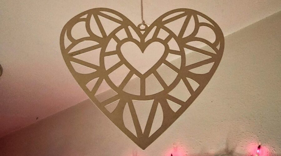 poster board cutout hearts hanging from the ceiling for valentine's day decorations www.emjaybeedesign.com